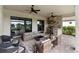 The patio has a seating area with outdoor furniture and a built-in stone kitchen with grill and stainless steel hood at 4735 Cassio Ct, Bradenton, FL 34211