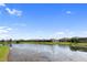 Scenic view of the community pond lined with manicured lawns and well-kept homes at 4735 Cassio Ct, Bradenton, FL 34211