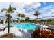 The sparkling community pool is surrounded by palm trees and ample seating, a perfect spot for relaxation at 4735 Cassio Ct, Bradenton, FL 34211