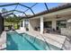 A screened-in pool area with a covered patio, outdoor furniture, and a built-in bar provides an ideal space for entertaining and relaxation at 4735 Cassio Ct, Bradenton, FL 34211