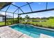 Private screened-in pool area with views of the peaceful lake and lush landscaping at 4735 Cassio Ct, Bradenton, FL 34211