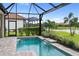Enjoy the view of a lush backyard, lake and neighborhood from the screened in pool with its stone deck and flowing water feature at 4735 Cassio Ct, Bradenton, FL 34211