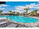 Large pool area with lounge chairs, palm trees, and sunny skies at 4735 Cassio Ct, Bradenton, FL 34211