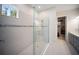 Modern shower with glass enclosure, decorative tile, and a view to the walk-in closet at 4735 Cassio Ct, Bradenton, FL 34211