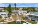 Beautiful backyard featuring a screened pool, boat dock, and lush landscaping, ideal for outdoor entertainment at 4819 Palmetto Point Dr, Palmetto, FL 34221