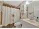 Bathroom with a palm tree shower curtain, tiled walls, and a vanity for a tropical oasis at 4819 Palmetto Point Dr, Palmetto, FL 34221