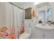 Cozy bathroom with a shower/tub combo, cute seahorse-themed curtain and storage cabinet at 4819 Palmetto Point Dr, Palmetto, FL 34221