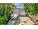 Large driveway with two-car garage and a boat with a trailer at 4819 Palmetto Point Dr, Palmetto, FL 34221