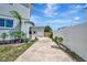 Long driveway featuring a modern home design with lush landscaping and privacy fence at 4819 Palmetto Point Dr, Palmetto, FL 34221