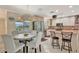 Bright eat-in kitchen with stainless steel appliances, countertop seating and a charming breakfast table at 4819 Palmetto Point Dr, Palmetto, FL 34221
