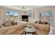 Cozy living room with plush sofas, a TV, and natural light streaming in from multiple windows at 4819 Palmetto Point Dr, Palmetto, FL 34221