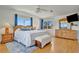 Bright main bedroom with hardwood floors, a king bed, and natural light from two windows at 4819 Palmetto Point Dr, Palmetto, FL 34221