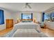 Bright main bedroom featuring hardwood floors, a king bed, and two windows with natural light at 4819 Palmetto Point Dr, Palmetto, FL 34221