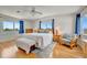 Bright main bedroom with hardwood floors, a king bed, and natural light streaming from multiple windows at 4819 Palmetto Point Dr, Palmetto, FL 34221