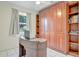 Charming office with custom desk and built in shelving for storage and showcasing books and décor at 4819 Palmetto Point Dr, Palmetto, FL 34221