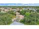 Aerial view of homes featuring lush trees, water views, and landscaped lawns at 5619 Oak Grove Ct, Sarasota, FL 34233