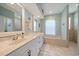 Well-lit bathroom with double sinks, a soaking tub, and a separate shower, offering a spa-like experience at 5619 Oak Grove Ct, Sarasota, FL 34233