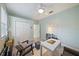 Bright bedroom featuring a ceiling fan, ample closet space, and natural light at 5619 Oak Grove Ct, Sarasota, FL 34233
