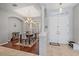 View of the formal dining room showcasing stylish lighting and beautiful hardwood floors at 5619 Oak Grove Ct, Sarasota, FL 34233