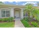 Inviting home entryway with decorative columns, and lush landscaping at 5619 Oak Grove Ct, Sarasota, FL 34233