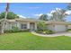 Charming home exterior with a well-manicured lawn and a two car garage at 5619 Oak Grove Ct, Sarasota, FL 34233