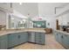 Updated kitchen with stainless steel appliances, tiled floors, and views to the living room at 5619 Oak Grove Ct, Sarasota, FL 34233