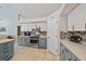 Charming kitchen with two-tone cabinets, mosaic backsplash, stainless appliances, and spacious countertops at 5619 Oak Grove Ct, Sarasota, FL 34233