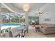 Bright living room featuring stylish furnishings, large windows overlooking the pool, and vaulted ceilings at 5619 Oak Grove Ct, Sarasota, FL 34233