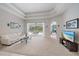 Spacious living room features a large window, white sofa, and access to the pool at 5619 Oak Grove Ct, Sarasota, FL 34233