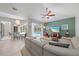Spacious living room with neutral tones, pool views, and a ceiling fan for a comfortable atmosphere at 5619 Oak Grove Ct, Sarasota, FL 34233