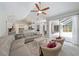 Open-concept living room with a cozy sofa, patio access, and views of the kitchen, perfect for entertaining at 5619 Oak Grove Ct, Sarasota, FL 34233