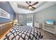 Serene main bedroom with a large bed, ceiling fan, and sliding doors offering pool views at 5619 Oak Grove Ct, Sarasota, FL 34233