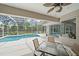 Covered patio featuring a screened-in pool and an outdoor seating area at 5619 Oak Grove Ct, Sarasota, FL 34233