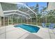 Sparkling pool with screened enclosure and patio seating, great for outdoor entertaining at 5619 Oak Grove Ct, Sarasota, FL 34233