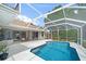 Backyard view of screened-in pool and outdoor living area of property at 5619 Oak Grove Ct, Sarasota, FL 34233