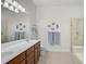 Bathroom with a large mirror, double sinks, and fish decor at 5662 Fossano Dr, Sarasota, FL 34238
