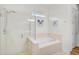 Bright bathroom showcasing a shower, soaking tub, and tile surround at 5662 Fossano Dr, Sarasota, FL 34238