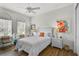 Bright bedroom features a ceiling fan, hardwood floors and lots of natural light at 5662 Fossano Dr, Sarasota, FL 34238