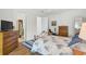 Comfortable bedroom featuring wood floors, ceiling fan and walk-in closet at 5662 Fossano Dr, Sarasota, FL 34238