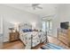 Inviting bedroom with ceiling fan, wood floors, and sliding glass door to patio at 5662 Fossano Dr, Sarasota, FL 34238