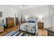 Spacious bedroom with wood floors, dressers, ceiling fan, and mirrors at 5662 Fossano Dr, Sarasota, FL 34238