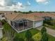 An inviting single-story home features a screened lanai and a well-manicured lawn with a brick-paved driveway and attached garage at 5662 Fossano Dr, Sarasota, FL 34238