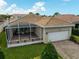 Aerial view of house featuring a screened-in patio, tile roof, and a well-manicured lawn at 5662 Fossano Dr, Sarasota, FL 34238