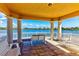 A gazebo features views of a tranquil lake and comfortable seating for relaxation and enjoyment of the serene surroundings at 5662 Fossano Dr, Sarasota, FL 34238