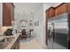 Bright kitchen area with stainless steel refrigerator and adjoining breakfast nook at 5662 Fossano Dr, Sarasota, FL 34238