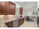 Modern kitchen featuring granite countertops, stainless steel appliances, and ample cabinet space at 5662 Fossano Dr, Sarasota, FL 34238