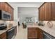 Well-lit kitchen featuring granite countertops and stainless steel appliances at 5662 Fossano Dr, Sarasota, FL 34238
