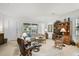 Well-lit living room with a cozy seating area and sliding glass doors to the backyard at 5662 Fossano Dr, Sarasota, FL 34238