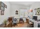 Home office featuring hardwood floors, a large window and a sizable desk setup at 5662 Fossano Dr, Sarasota, FL 34238