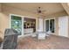 Covered patio featuring brick flooring, a ceiling fan, and access to both the yard and the home at 5662 Fossano Dr, Sarasota, FL 34238